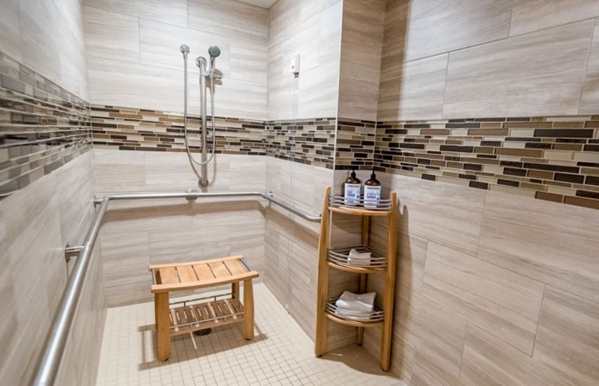 large shower with sitting bench