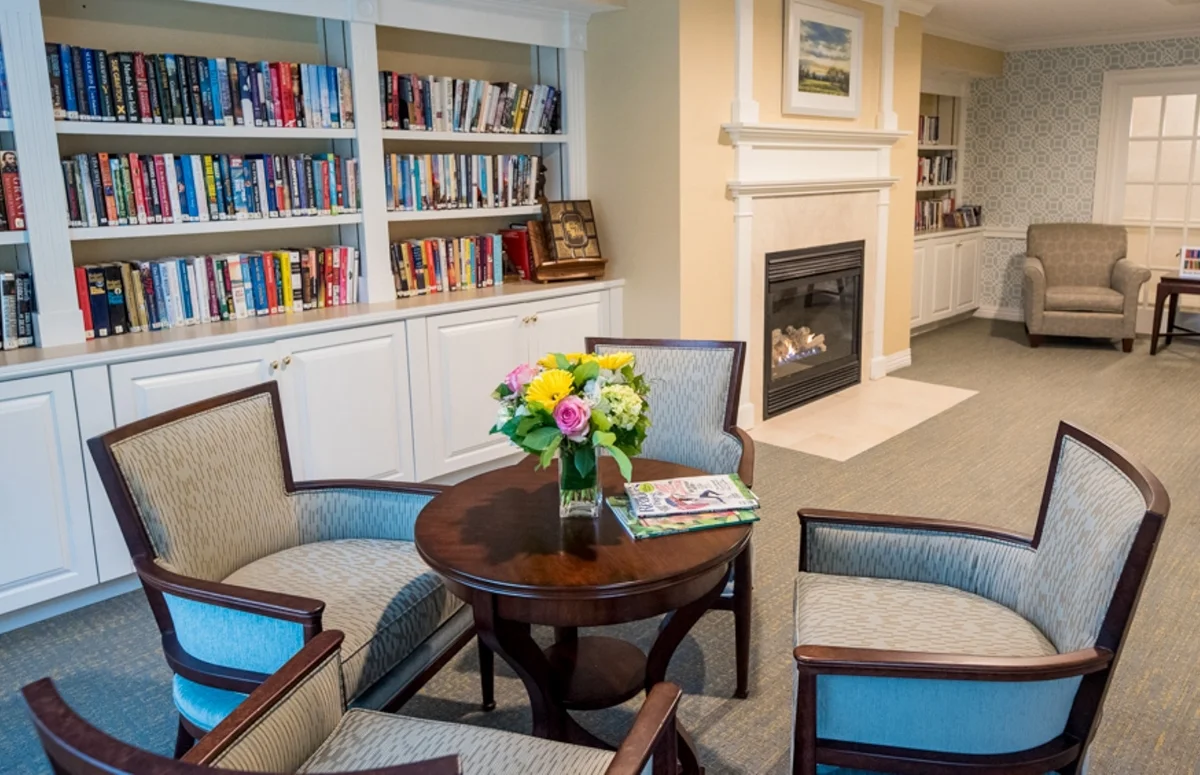 shared living area table and chairs and bookshelves